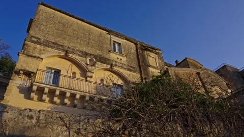 Sunset on a old stone building with trees in front of it Stock Footage 280716653