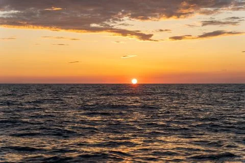Sunset in the open sea Stock Photos