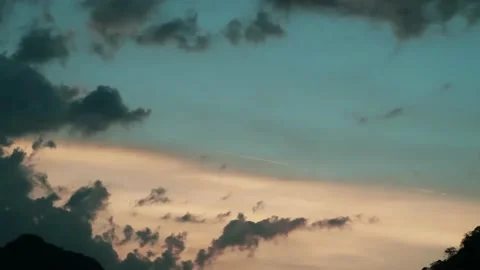 Sunset or sunrise dark gray cloud n white cloudscape on cyan blue sky Stock Footage 167930627