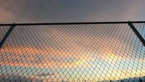 Sunset or sunrise through fance Stock Footage 204869084