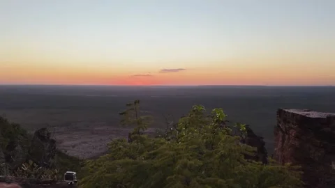 Sunset or sunrise view from a rocky cliff over a vast plain and landscape. Stock Footage 313240968
