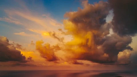 Sunset orange and grey clouds lit in blue sky Stock Footage 115184915