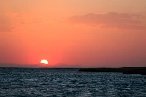 Sunset orange and red colors landscape, sea and sun with deep sky Stock Photos