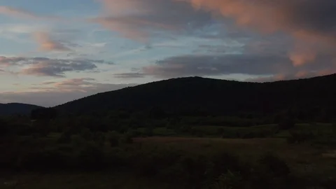 Sunset orange clouds above hills and lowlands Stock Footage 120696677