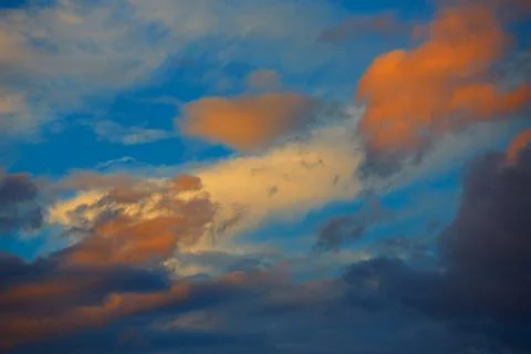 Sunset orange clouds in a blue sky Stock Photos