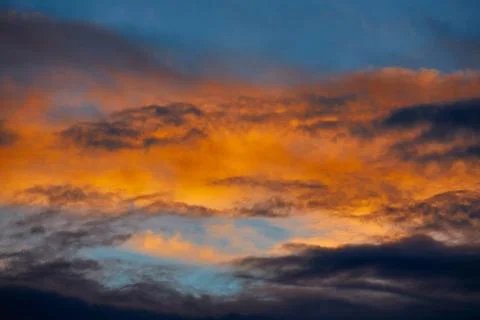 Sunset orange clouds in a blue sky Stock Photos