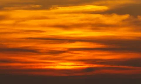 A sunset with orange clouds in the sky Stock Photos