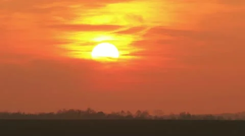 Sunset on orange red sky time-lapse - long shot Stock Footage 12364562