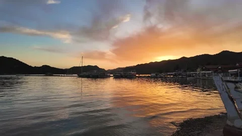 Sunset, orange sky and clouds on the beach Stock Footage 277984415