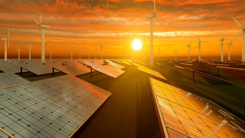 Sunset with orange sky over wind turbines and solar panel field Stock Footage 171622546