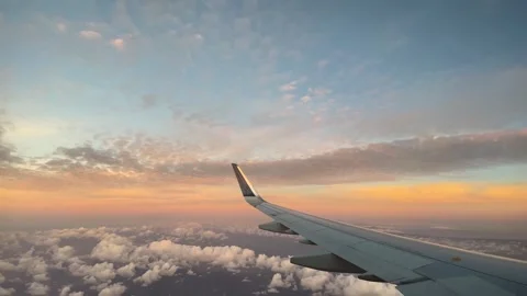 Sunset out airplane window of wing in flight Stock-Footage 249787297
