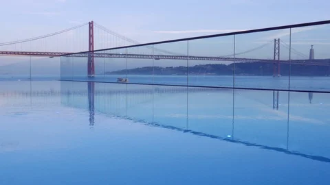 Sunset over the '25 of April' Bridge in Lisbon, Portugal with reflection from Video stock 103614220