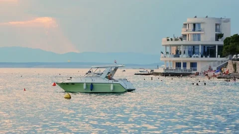 Sunset over Adriatic sea. View of the yacht and the hotel in the background. 4k 스톡 동영상 132015337