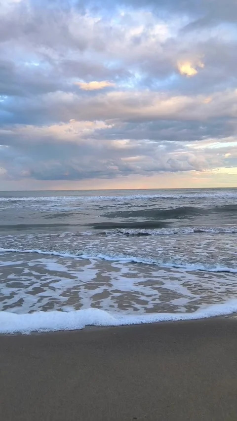 Sunset over Adriatic sea waves on beach in Italy Видео 345115836