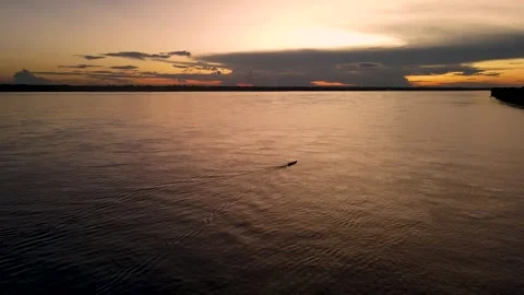 Sunset over the Amazon River with a boat Stock Footage 330925721