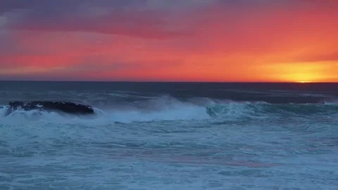 Sunset Over the Atlantic Ocean with Crashing Waves and a Rocky Shoreline in Icel Stock Footage 320202304