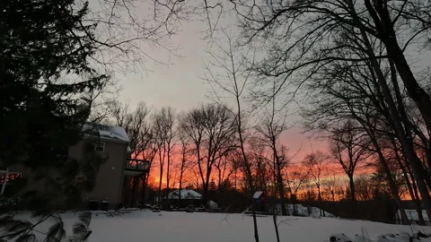Sunset over back yard covered with snow in January Stock Footage 321430866