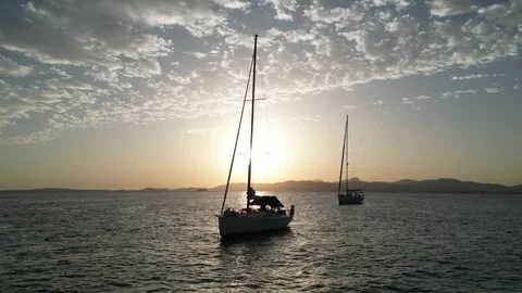 Sunset over Badia de Palme with crusing yacht Stock Footage 285443989