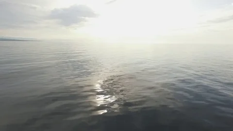 Sunset over Baikal water - low angle aerial shot moving left Видео 80553340