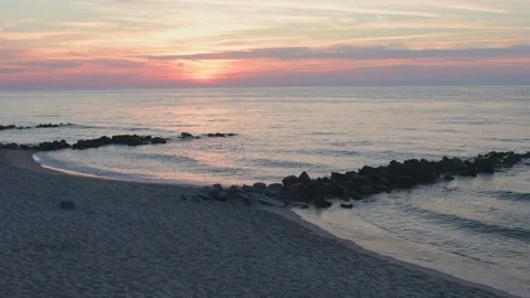 Sunset over Baltic Sea with breakwaters and beach in the foreground. Stock Footage 171227267