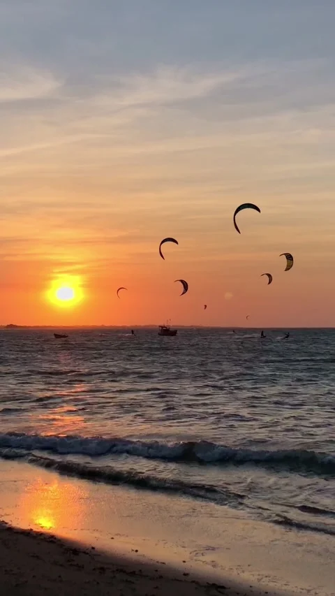 Sunset over Barra Grande Beach, Piauí, Brazil. Silhouettes of kitesurfers Stock Footage 319485484