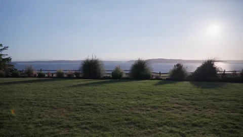 Sunset Over the Bay and Well-Groomed Lawn Stock Footage 314030675