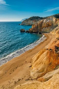 Sunset over beach, cliffs and hills and deep azure sea. Agios Ioannis beach Stock Photos