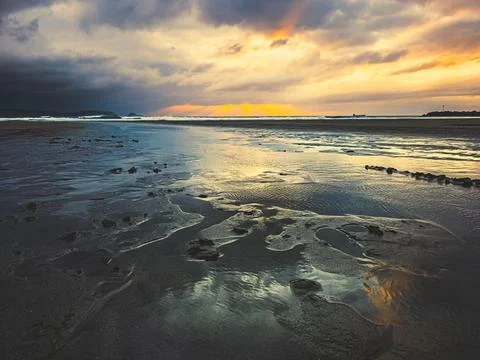 Sunset over beach with golden light in Aviles, Asturias, Spain, Stock-Fotos