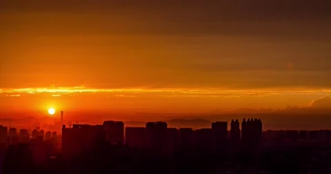 Sunset over Beijing city skyline with vibrant orange clouds and urban silhouette Video stock 342105296