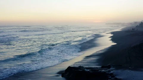 Sunset over a black sand beach in Bali Stock Footage 112585490