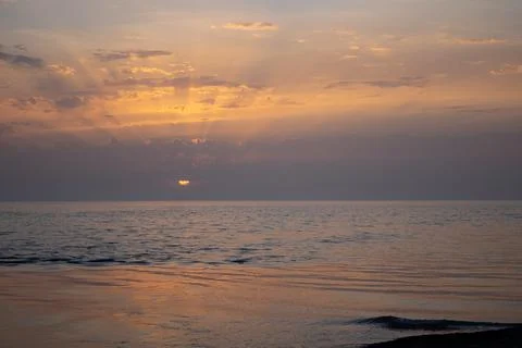 Sunset over the Black Sea. The rays of the sun break through the clouds Stock Photos