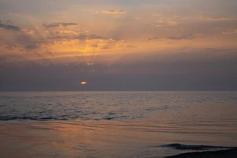 Sunset over the Black Sea. The rays of the sun break through the clouds Stock Photos