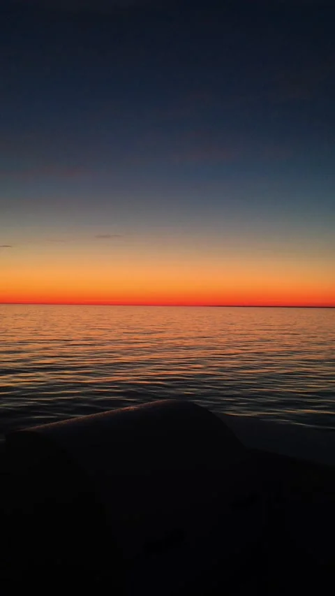 A sunset over a body of water. View from bridge of cargo ship Video stock 131583076