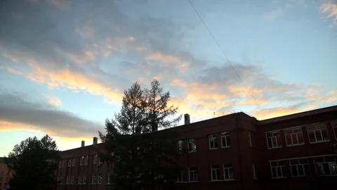Sunset over a brick building timelapse Stock Footage 76395932