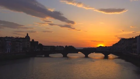 Sunset over bridge through the river Arno in Florence, Italy, time-lapse Stock Footage 72607840