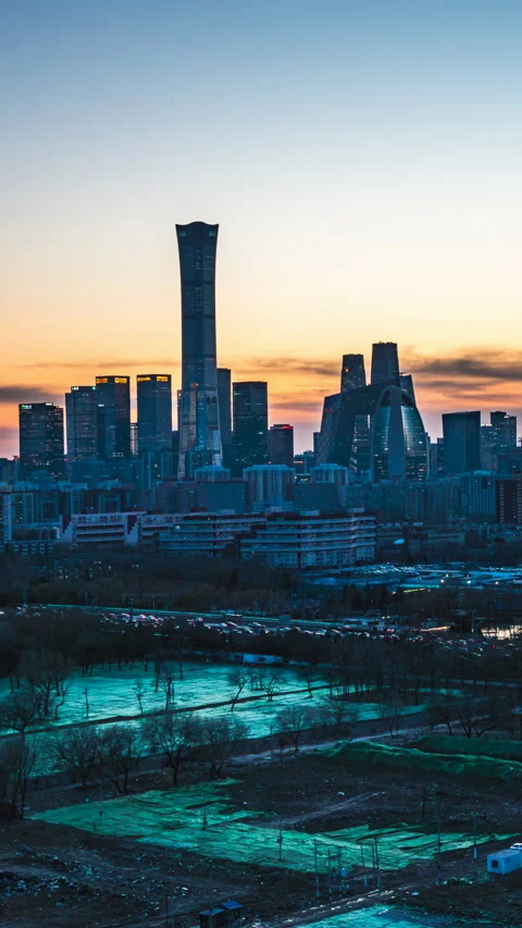 The sunset over the building complex in Beijing's CBD, with the afterglow of the Stock Footage 298325228