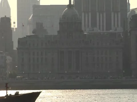 Sunset over the bund and slow pull out as barge passes Stock Footage 10891146