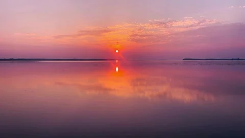 Sunset over a calm lake with beautiful orange sky reflection Vídeo Stock 336668360