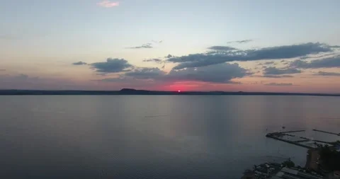 Sunset Over Calm Lake With Distant Clouds Stock Footage 311559520