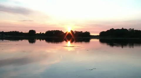 Sunset over Calm Lake with Rocks Thrown 動画素材 12575568