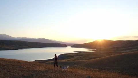 Sunset over a calm lake surrounded by golden autumn hills. Stock Footage 314993498