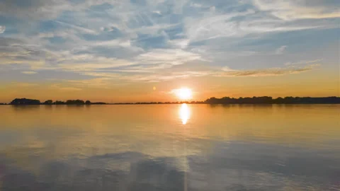 Sunset over calm lake timelapse Stock Footage 346156841