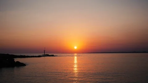 Sunset over calm ocean Stock Footage 97898352