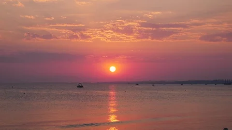 Sunset over calm ocean Video stock 97974660