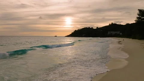 Sunset over a calm ocean with gentle waves on the shore. Seychelles, Mahe. Stock Footage 302510396
