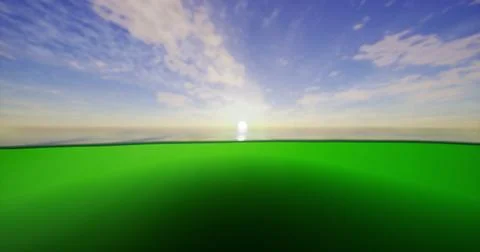 Sunset over the calm ocean with a green foreground and vibrant sky Ilustração Stock