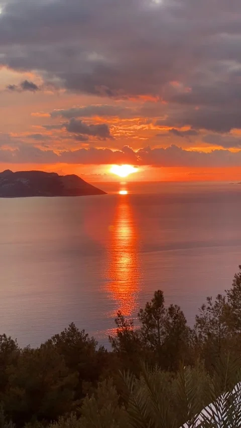Sunset over calm ocean horizon with vibrant orange sky, perfect for backgro.. Stock Footage 311916627