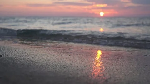 Sunset Over Calm Ocean Shore With Reflective Wet Sand and Gentle Waves at Dusk Stock Footage 337419361