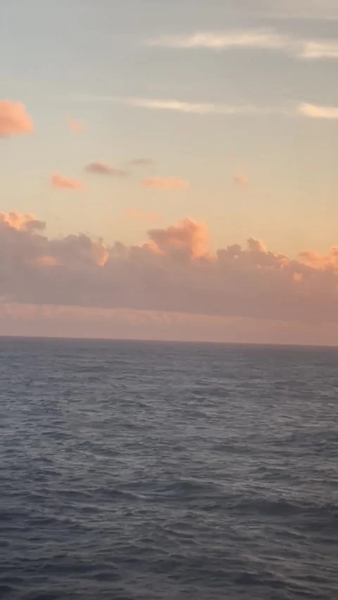 Sunset over the calm ocean with vibrant colors and soothing waves Stock Footage 321899580