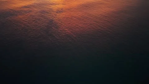 Sunset over calm ocean waters with distant island and colorful sky Video stock 342332714